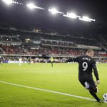 D.C. United forward Wayne Rooney takes a corner kick