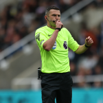 Premier League referee Michael Oliver blows a whistle