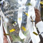 A player lifting the Champions League Trophy