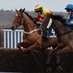 Horses jumping a fence at Ascot