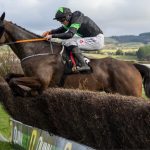Where It All Began jumping a fence at Punchestown on the way to winning the Grand National Trial